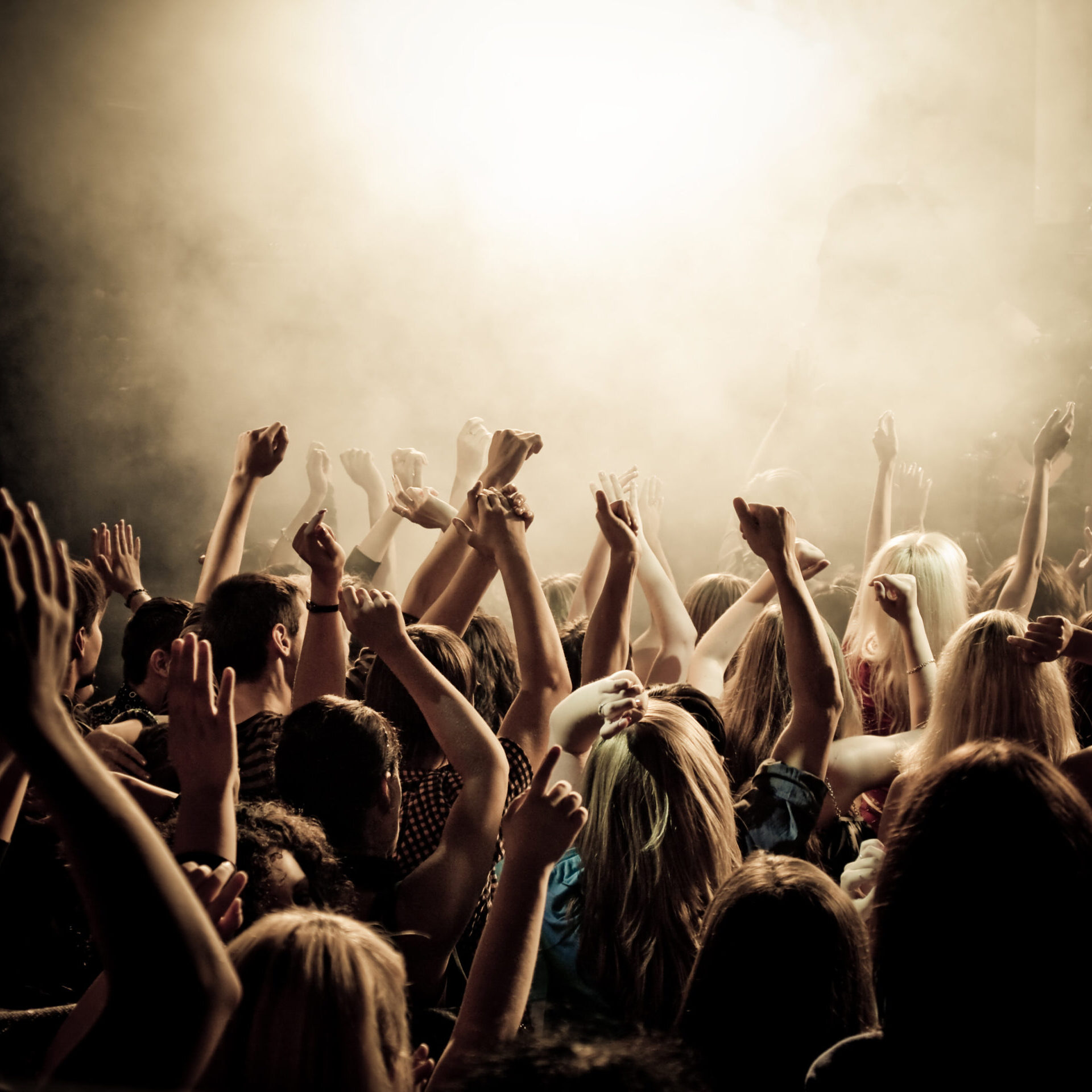 Crowd at a concert with hands up