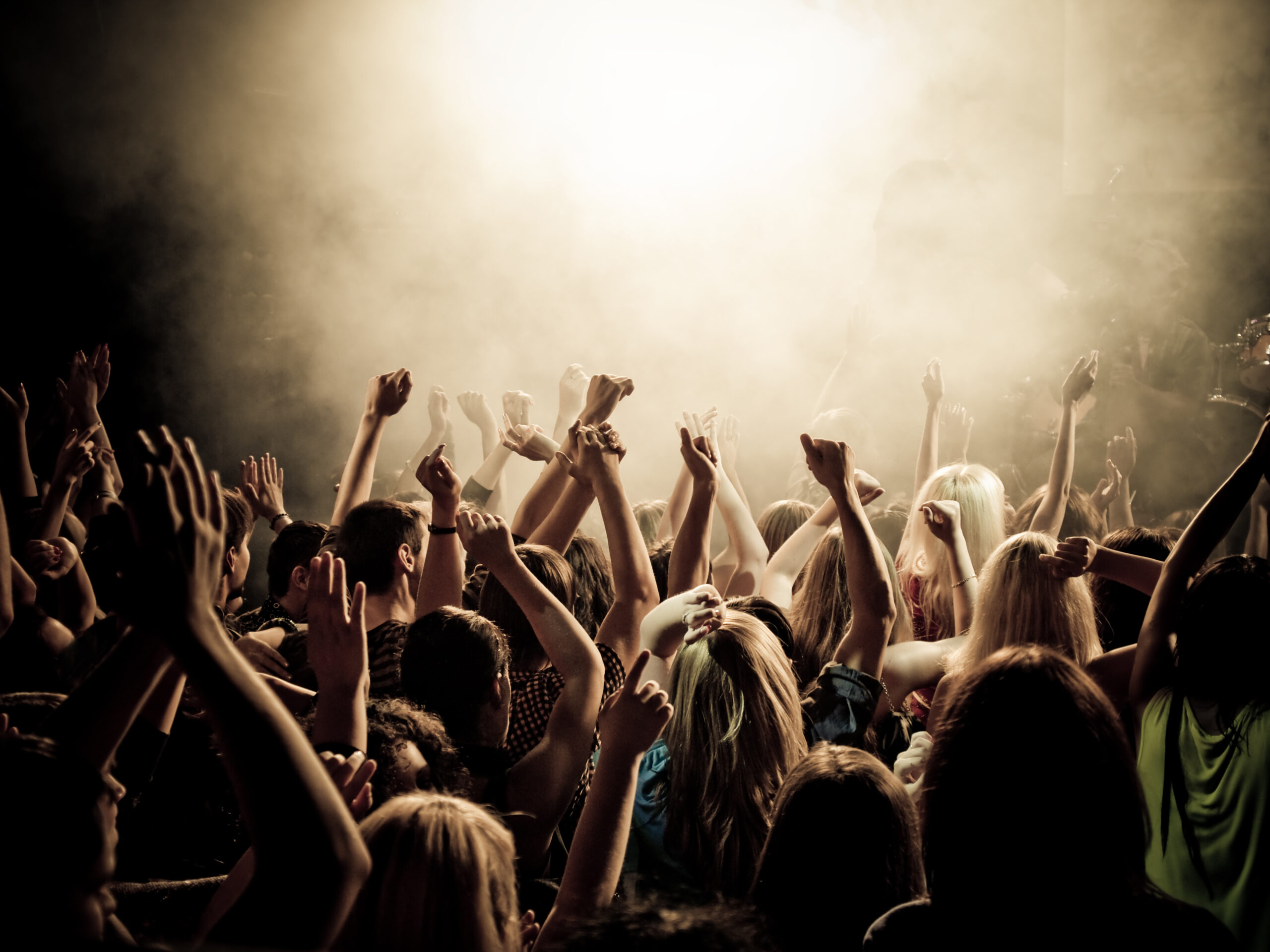 Crowd at a concert with hands up